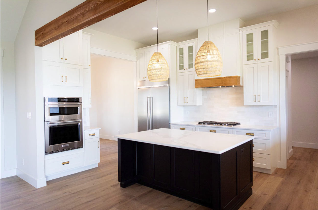 White shaker kitchen with marble-top black island