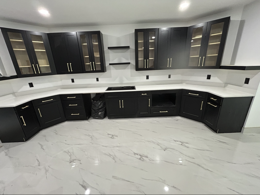 Black cabinets, white quartz tops, marble floor