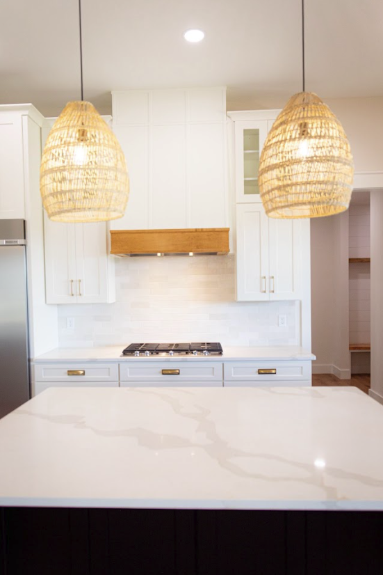 Calacatta island under rattan pendants